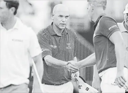  ?? ASSOCIATED PRESS FILE PHOTO ?? Bill Haas, centre, shakes hands with Henrik Stenson after the first round of the Wyndham Championsh­ip golf tournament, in Greensboro, N.C. Haas returns to golf this week, playing for the first time since he was the passenger in a car accident that...