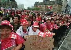  ?? FRED CHARTRAND/THE CANADIAN PRESS ?? Thousands braved the rain to celebrate Canada Day on Parliament Hill in Ottawa. The wet weather meant there was no Snowbirds air show this year.