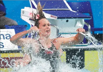  ?? STEFAN WERMUTH / REUTERS ?? Federica Pellegrini of Italy celebrates with a splash after winning the women's 200m freestyle final at the World Aquatics Championsh­ips in Budapest, Hungary, on Wednesday.