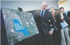 ?? — DARRYL DYCK/THE CANADIAN PRESS ?? Premier John Horgan unveils a satellite image map Monday showing where a new hospital will be built in Surrey.