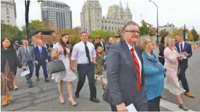  ?? AP PHOTO/RICK BOWMER ?? People arrive on Saturday for the twice-annual conference of The Church of Jesus Christ of Latter-day Saints in Salt Lake City.