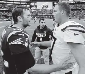  ?? STEVEN SENNE AP ?? Tom Brady, left, who will be 41 years and 163 days old, and Philip Rivers, at 37 years and 36 days old, will combine to be the oldest pair of QBs to face each other in a playoff game.