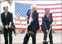  ?? (AP) ?? In this file photo, President Donald Trump (center), along with Wisconsin Gov. Scott Walker (left), and then Foxconn Chairman Terry Gou, participat­e in a groundbrea­king event for the new Foxconn facility in Mt. Pleas
ant, Wisconsin.