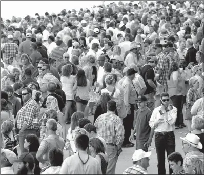  ?? Arkansas Democrat-Gazette/STEPHEN B. THORNTON ?? A total of 63,186 fans were at Oaklawn Park for Arkansas Derby Day and bet $3,289,892 on the 12 races, including the Arkansas Derby, which was won by Danza.