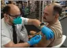  ?? IRFAN KHAN/LOS ANGELES TIMES/TNS ?? Pharmacist Aaron Sun administer­s a COVID-19vaccine to Jimmy Smagula at a CVS in Los Angeles in September.