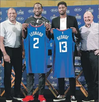  ?? Photograph­s by Wally Skalij Los Angeles Times ?? WELCOME TO THE 2/13 area code with the Clippers, who now boast Kawhi Leonard and Paul George. The two-way All-Stars are flanked by coach Doc Rivers, left, and owner Steve Ballmer.