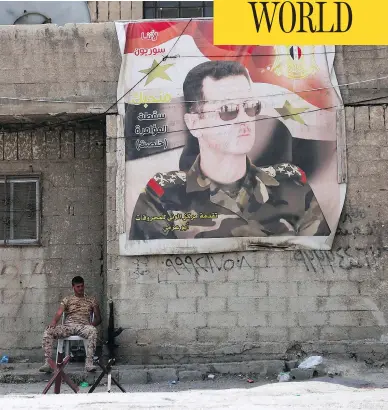  ?? YOUSSEF KARWASHAN / AFP / GETTY IMAGES ?? A Syrian soldier sits by the entrance of the Wafideen Camp ahead of the arrival of rebels and their families evacuated from the Eastern Ghouta town of Douma Thursday, ending one of the bloodiest assaults of Syria’s seven-year war.