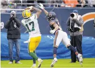  ?? NAM Y. HUH/ASSOCIATED PRESS ?? Green Bay wide receiver Davante Adams scores a touchdown against Chicago and Bears cornerback Kyle Fuller during Sunday’s game at Soldier Field.