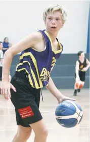  ??  ?? Bunyip Saints player Cooper Pursell protects the ball as he seeks out a teammate.