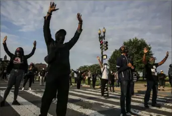  ?? Oliver Contreras/Washington Post ?? People pray near the National Museum of African American History and Culture during a prayer walk Sunday in Washington, D.C.