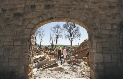  ?? Erik Castro / Special to The Chronicle ?? Soda Rock Winery owner Ken Wilson ( right) with his daughter Victoria Wilson, look over the remains of his winery, which was destroyed during the 2019 Kincade Fire in Healdsburg.