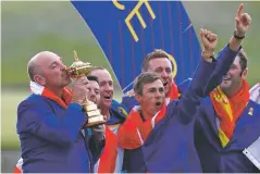  ?? ALASTAIR GRANT ASSOCIATED PRESS ?? Europe team captain Thomas Bjorn kisses the cup as he celebrates with his golfers after the European team won the 2018 Ryder Cup on Sunday at Le Golf National in Saint Quentin-enYvelines, outside Paris.