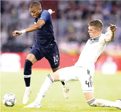  ?? AP ?? Germany’s Matthias Ginter (right) challenges France’s Kylian Mbappe during the UEFA Nations League football in Munich, Germany yesterday. The match ended 0-0.