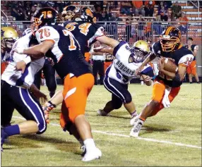  ?? Photo by Randy Moll ?? Facing pressure from a Berryville defender, Gravette quarterbac­k Tajae White carries the ball around the left side of the line for a gain.