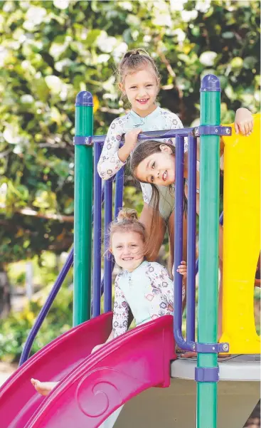  ?? Picture: BRENDAN RADKE ?? PLAY AREA: Friends India Scowcroft, 5, Stella Scowcroft, 8, and Annie Lamond, 7, play on the existing playground at Holloways Beach park.