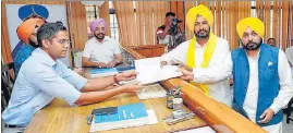  ?? HT PHOTO ?? Punjab chief minister Bhagwant Mann accompanyi­ng AAP’s Sangrur district chief Gurmail Singh, 38, as he files his nomination papers for the Lok Sabha bypoll on Saturday.