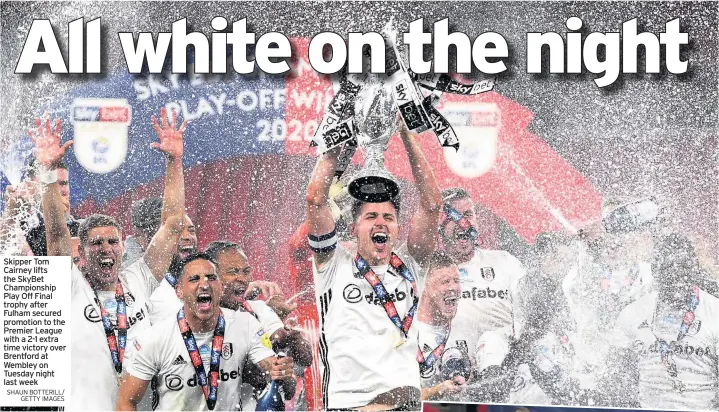  ?? SHAUN BOTTERILL/ GETTY IMAGES ?? Skipper Tom Cairney lifts the SkyBet Championsh­ip Play Off Final trophy after Fulham secured promotion to the Premier League with a 2-1 extra time victory over Brentford at Wembley on Tuesday night last week