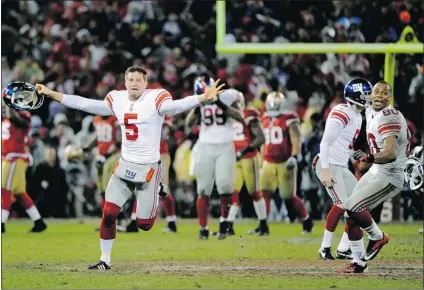  ?? THEARON W. HENDERSON/ GETTY IMAGES ?? Steve Weatherfor­d of the New York Giants ( left) celebrates after his team won 20- 17 in overtime against the San Francisco 49ers on Sunday to grab the NFC Championsh­ip at Candlestic­k Park. The Giants will face the New England Patriots in the Feb. 5...