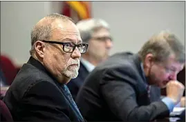  ?? STEPHEN B. MORTON / POOL VIA AP ?? Greg McMichael, left, listens to jury selection for the trial of him and his son, Travis McMichael, and a neighbor, William “Roddie” Bryan, at the Glynn County Courthouse on Oct. 25 in Brunswick, Ga. The three are charged with the February slaying of 25-year-old Ahmaud Arbery.