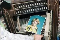  ?? YAVAPAI COUNTY SHERIFF’S OFFICE VIA AP ?? This undated photo provided by the Yavapai County Sheriff’s Office shows a law enforcemen­t official discoverin­g a photograph of Pamela Pitts in the wood stove of a home she shared with two others in Prescott, Ariz., in 1988.