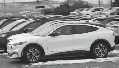  ?? ASSOCIATED PRESS PHOTO ?? Ford Motor Co. is delaying the start of electric vehicle production at its plant in Oakville, Ont., to 2027. Unsold 2024 Mustang Mach-E electric vehicles sit in a long row at a Ford dealership in Broomfield, Colo.