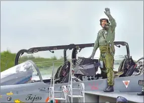  ?? PTI ?? Union Defence Minister Rajnath Singh waves from atop the Light Combat Aircraft (LCA) Tejas after a sortie at HAL airport in Bengaluru, Thursday