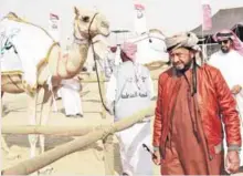  ??  ?? Sheikh Sultan Bin Zayed al-Nahyan inspects camels during the camel festival, held at the Shweihan racecourse, in Al-Ain on the outskirts of Abu Dhabi. — AFP