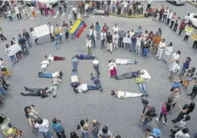  ?? (photo: afp) ?? Health workers form a human chain reading “SOS” during a protest for the lack of medicines, medical supplies and poor conditions in hospitals, in Caracas, Venezuela, last year.