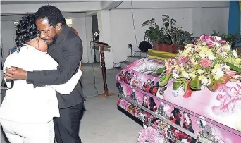  ??  ?? Wayne Marshall (right) and Latoya Riley, mother of Yetanya, comfort each other at the thanksgivi­ng service for the 14-year-old, which was held at the Half-Way-Tree Seventh-day Adventist Church, St Andrew, yesterday.