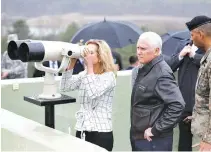  ?? REUTERS ?? US VICE-PRESIDENT Mike Pence stands next to his daughter looking toward the north through a pair of binocular from an observatio­n post inside the demilitari­zed zone separating the two Koreas, in Paju, South Korea, April 17.