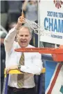  ?? AMBER SEARLS / USA TODAY ?? Michigan coach John Beilein cuts down the net after the Wolverines beat Wisconsin for the Big Ten tournament title. Story on 4B.