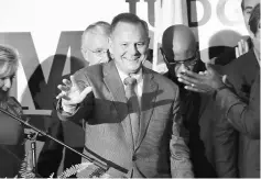  ??  ?? Moore (right) greets supporters at an election-night rally in Montgomery, Alabama. — AFP photo