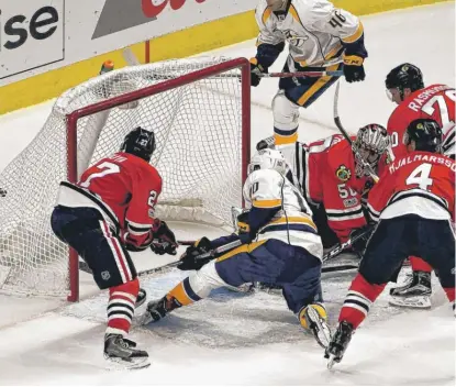  ??  ?? Colton Sissons scores to give the Predators a 3- 0 lead in the second period Saturday at the United Center. | DAVID BANKS/ AP