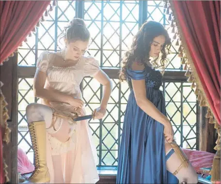  ?? Jay Maidment Sony Pictures Releasing ?? BELLA HEATHCOTE, left, and Lily James show a protective instinct for the Bennet family in “Pride and Prejudice and Zombies.”