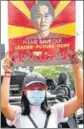  ?? REUTERS ?? A demonstrat­or holds up a placard with the image of Aung San Suu Kyi in Yangon, Myanmar, on Monday.