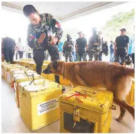  ??  ?? HIGH-RISK MISSION — Even before dawn breaks, armored personnel carriers escort eight military trucks delivering the ballot boxes to the Batasan Pambansa in Quezon City for the start of the national canvassing of votes for president and vice president,...