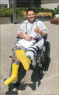  ?? Courtesy photo ?? Los Angeles County sheriff’s Deputy Garrett Rifkin gives a thumbs-up outside the hospital after his leg was amputated.