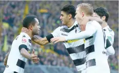  ?? — Reuters ?? Borussia Moenchengl­adbach’s Raffael celebrates with his teammates Mahmoud Dahoud and Oscar Wendt after scoring a goal.