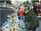  ?? CHRIS JACKSON/GETTY ?? Mourners leave flowers outside Windsor Castle on Thursday in Windsor, England.
After a life of prep work, Charles takes the throne. He will be known as King Charles III. Page 14