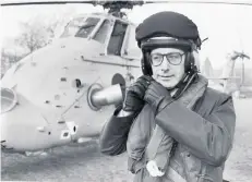  ??  ?? Malcolm Rifkind adjusts his helmet before flying to Leuchars by helicopter.