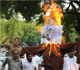  ?? — BIPLAB BANERJEE ?? People burn an effigy of separatist leader Mirwaiz Umar Farooq in New Delhi on Saturday to protest against the lynching of a police officer in Kashmir.