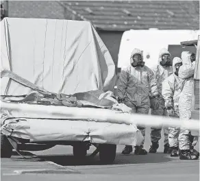  ??  ?? British military personnel remove a vehicle connected to the March 4 nerve agent attack in Salisbury. ADRIAN DENNIS/AFP/GETTY IMAGES