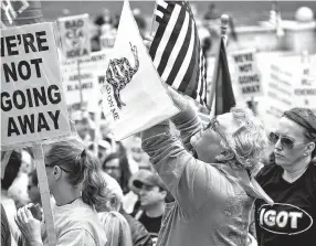  ??  ?? People rally at the annual Illinois Gun Owners Lobby Day on April 25 at the Capitol in Springfiel­d, Ill. At least 20 Illinois counties and officials in Oregon and Washington have asked for copies of a county’s resolution on gun rights.