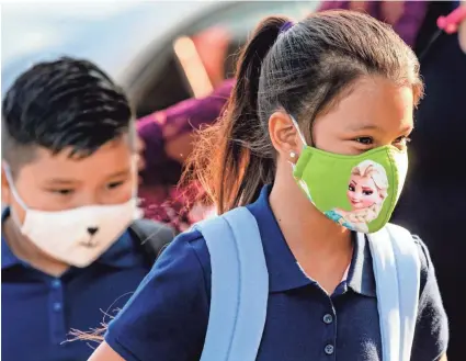  ?? PHOTOS BY CHRIS LANDSBERGE­R/THE OKLAHOMAN ?? Students arrive in the drop-off lane Aug. 9 at Rockwood Elementary for Oklahoma City Public Schools’ first day of class.