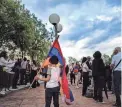  ?? OLIVIER CHASSIGNOL­E/AFP VIA GETTY IMAGES ?? Armenia’s supporters take part in a demonstrat­ion against Azerbaijan in Lyon, eastern France, but the cease-fire still held fast on Thursday.