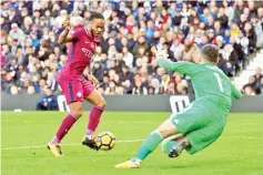  ??  ?? Manchester City’s English midfielder Raheem Sterling (L) scores the team’s third goal past West Bromwich Albion’s English goalkeeper Ben Foster during the English Premier League football match between West Bromwich Albion and Manchester City at The...