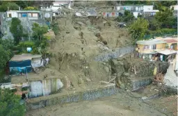  ?? SALVATORE LAPORTA/AP ?? An aerial view of damaged houses and other buildings Sunday after heavy rainfall triggered landslides in Casamiccio­la, on the southern Italian island of Ischia.