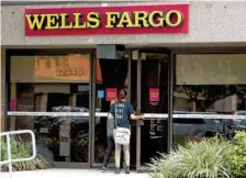  ??  ?? Customers walk into a Wells Fargo bank in Pembroke Pines, Fla., last week.