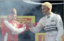  ?? PICTURE: EPA ?? Lewis Hamilton (right) shakes hands with Sebastian Vettel after winning the Italian GP at the legendary Monza track on Sunday. Afterwards both drivers insisted Monza has to stay.