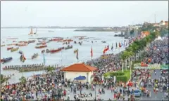  ?? SUPPLIED ?? Thousands of people crowd Phnom Penh’s riverside to watch traditiona­l boat races during Water Festival celebratio­ns in 2014.